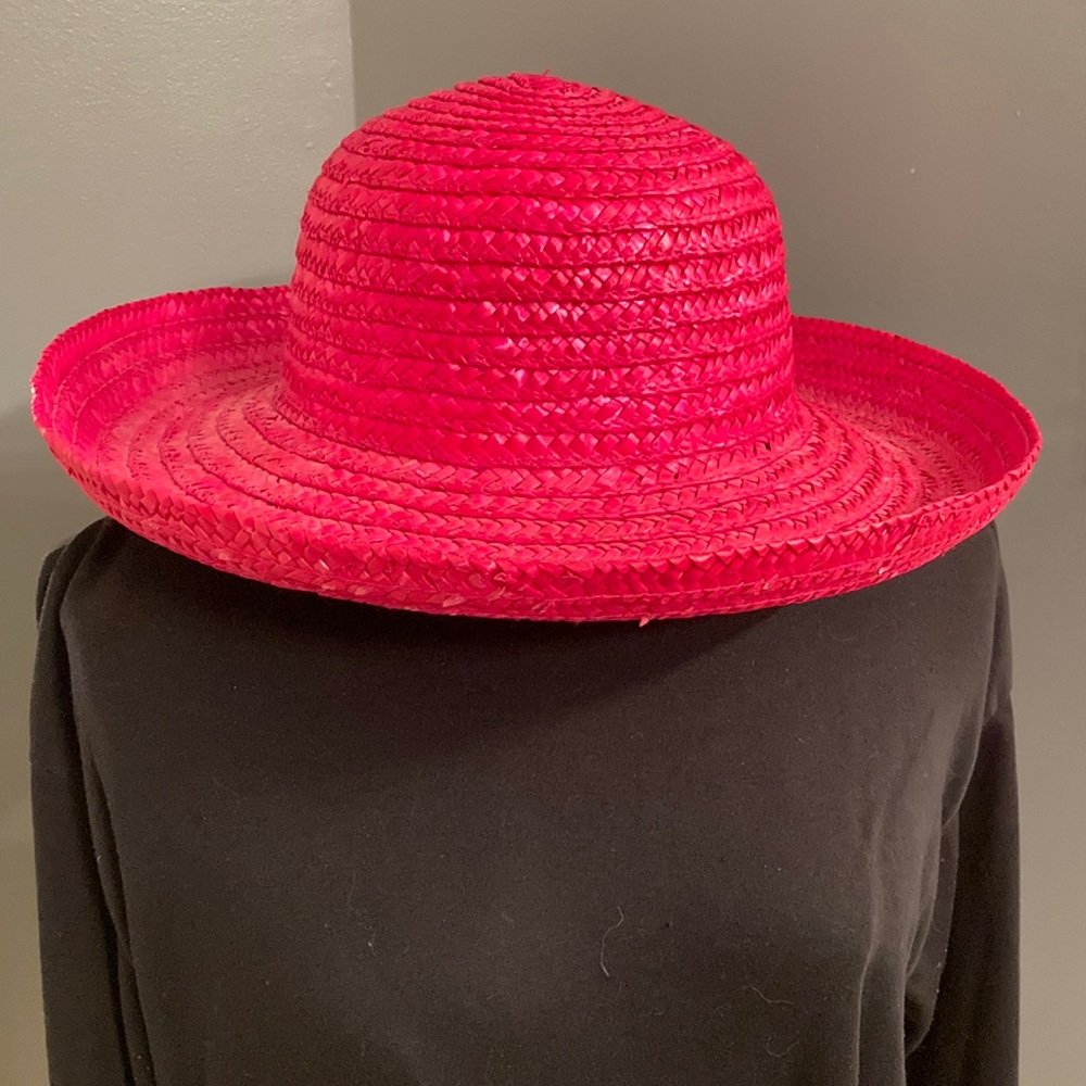 Pink straw hat with a wide brim